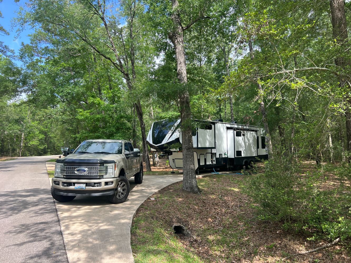 Our fifth wheel at a wooded campsite